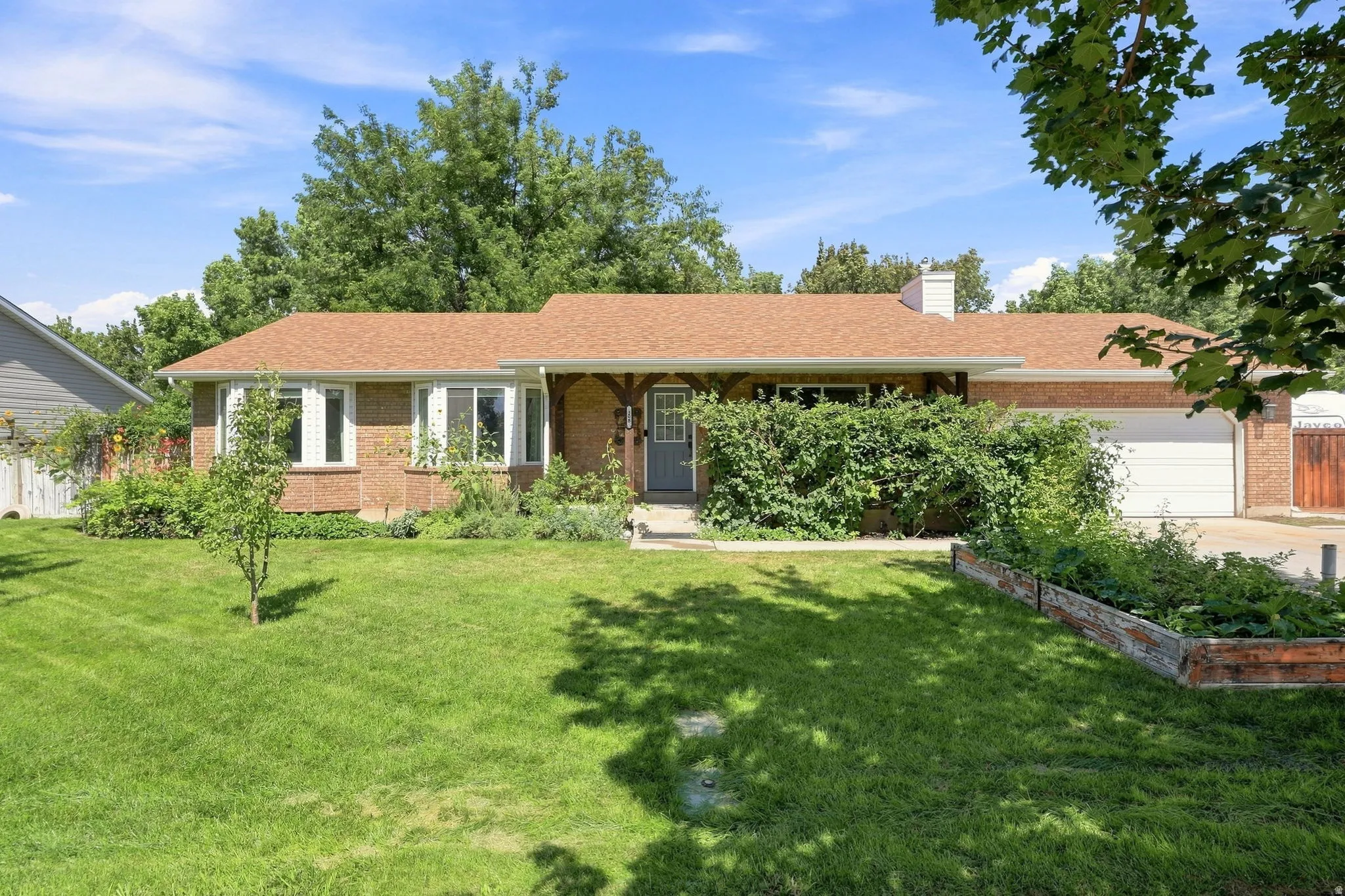 Brick exterior with a brown shingle roof