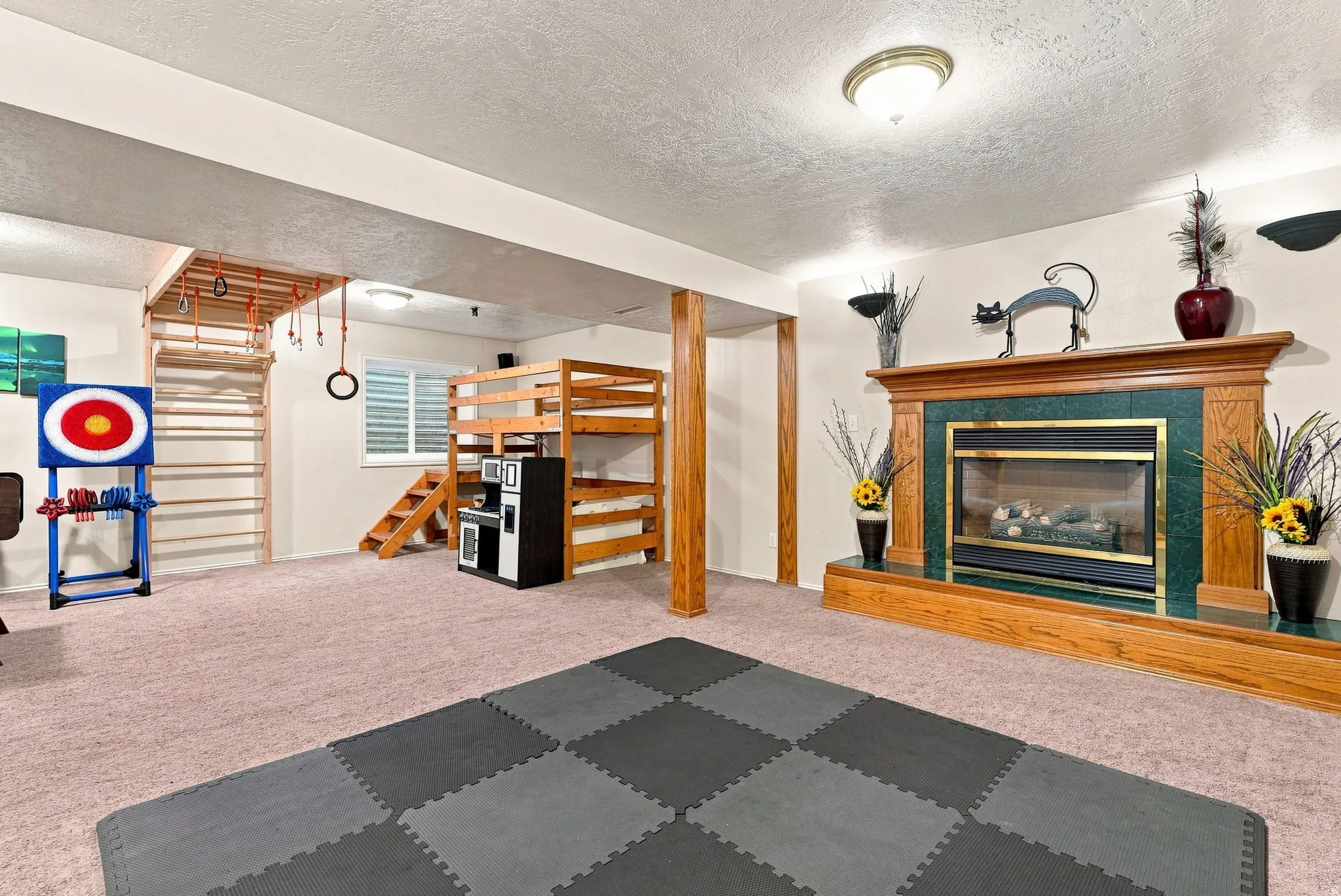 Fireplace with a wood surround and green tile accents