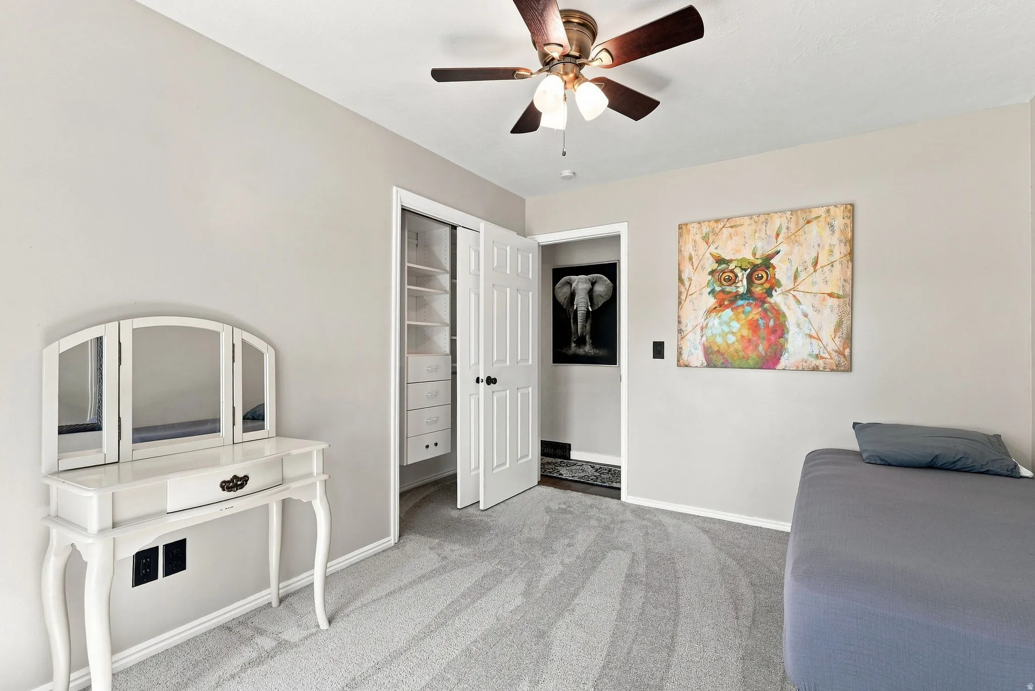 Carpeted room featuring a ceiling fan with integrated lighting