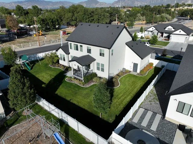 Two-story residence featuring a dark shingle roof, white siding, and a covered balcony