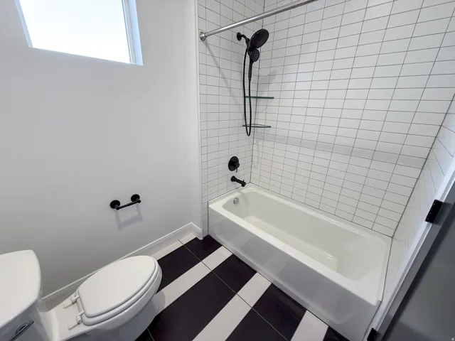 White subway tile shower surround with matte black fixtures
