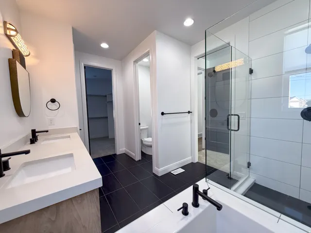 Dual vanity with white undermount sinks and matte black fixtures