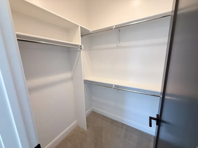 Built-in closet shelving system with multiple storage rods and shelves