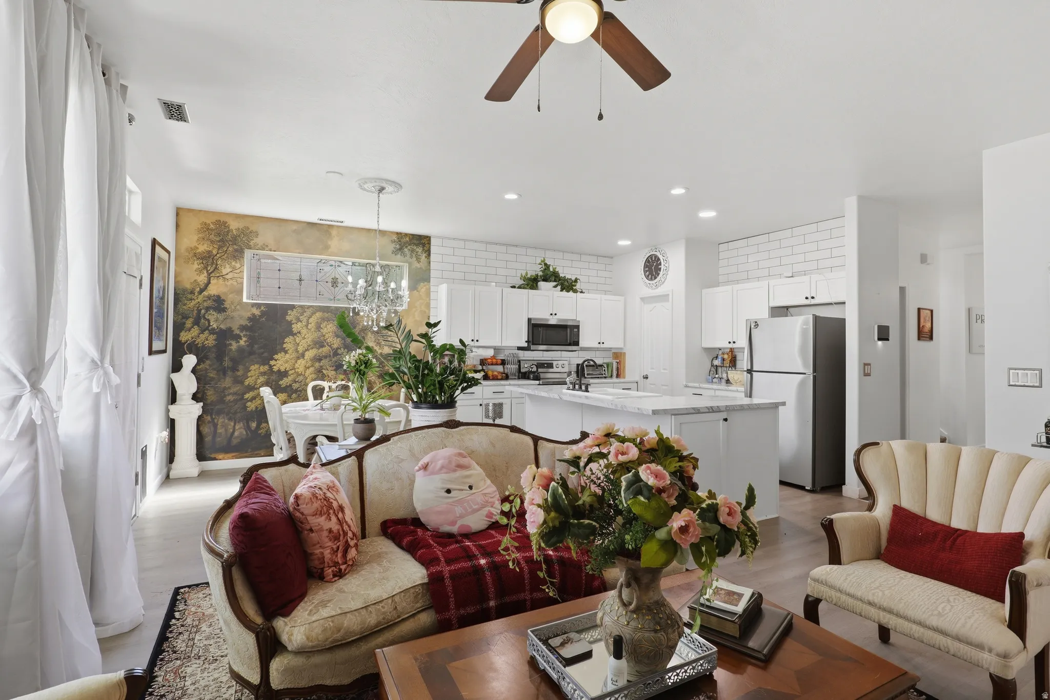 Open-concept living space featuring wood-finish flooring, recessed lighting, and a ceiling fan