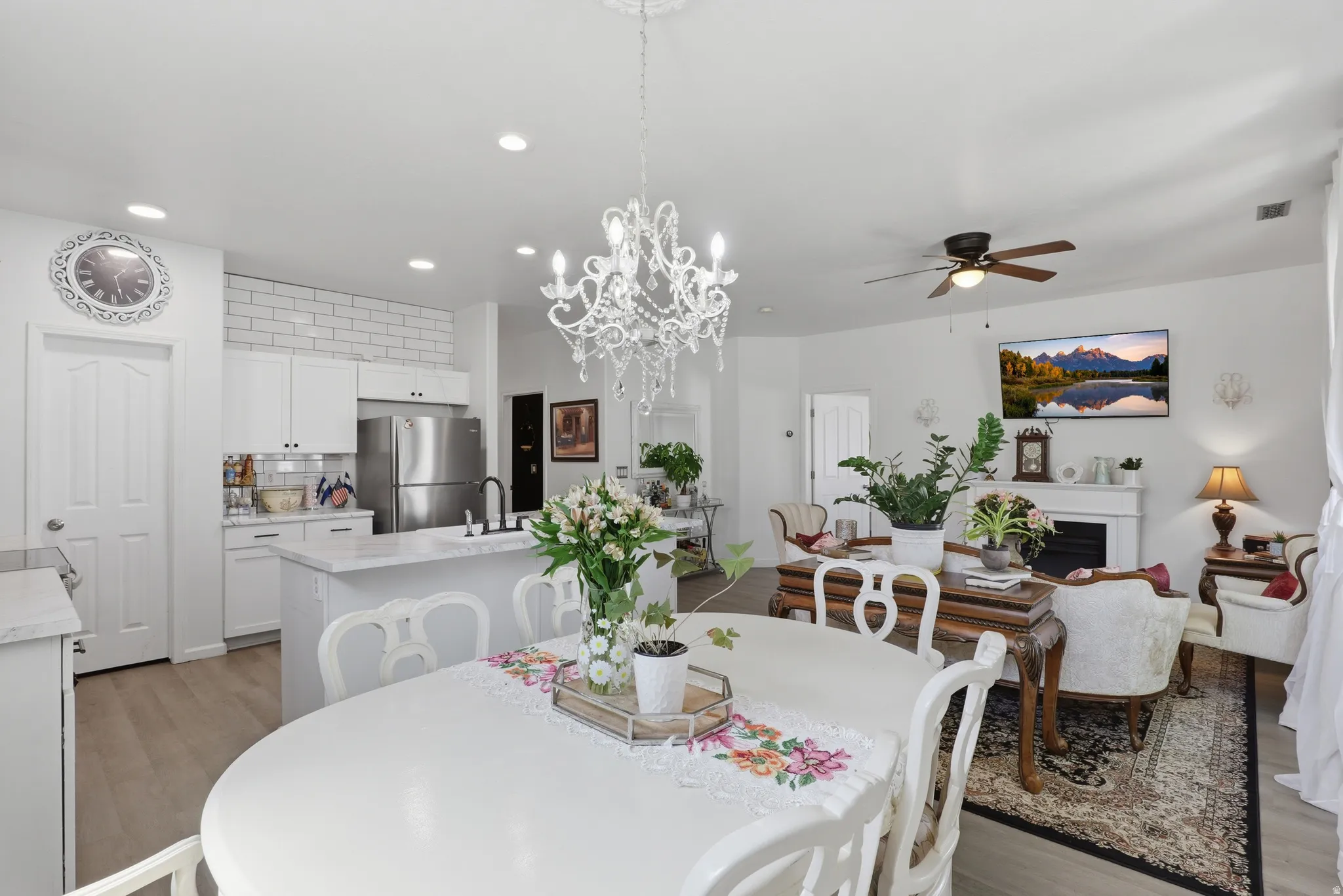 Open-concept living area featuring a decorative chandelier, recessed lighting, and wood-finish flooring