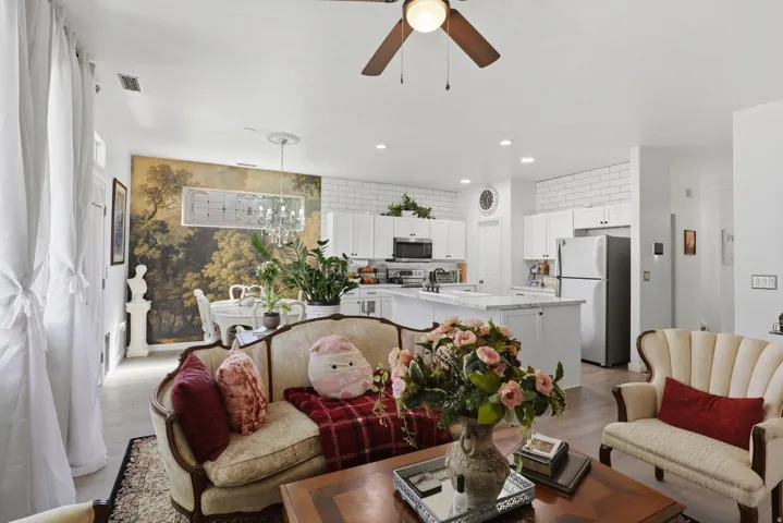 Open-concept living space featuring wood-finish flooring, recessed lighting, and a ceiling fan