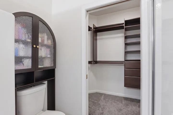 Custom closet system with multiple rods, shelving, and drawers