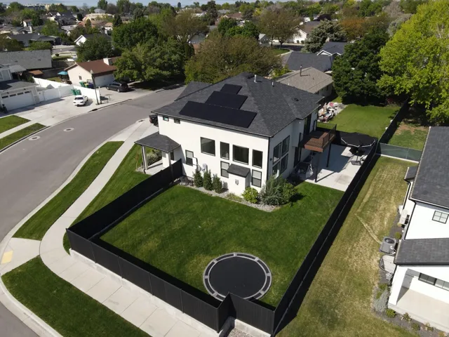 Contemporary exterior with multiple large windows, dark grey roof, and installed solar panels