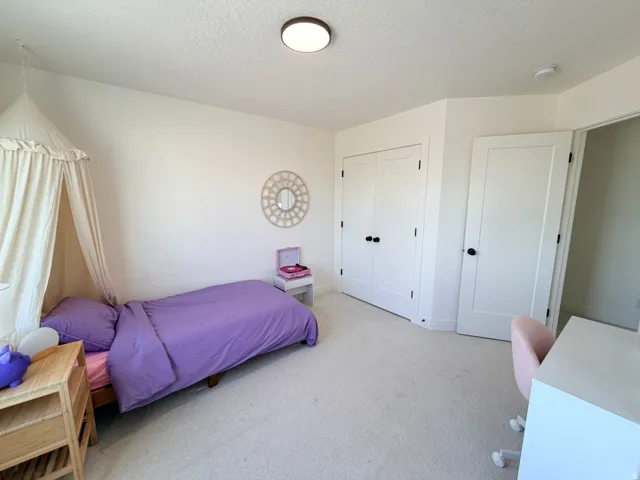 Plush carpeting, recessed lighting, and a neutral color palette