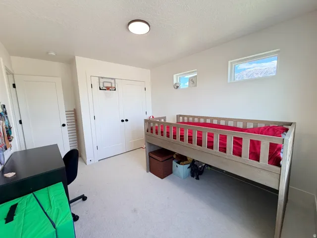 Recessed ceiling lighting, two horizontal windows, white flat-panel doors, and neutral wall paint
