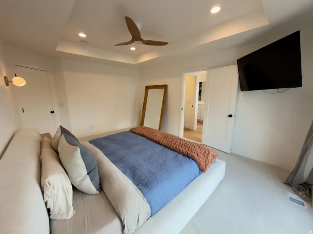 Recessed lighting, wood-finish ceiling fan, and tray ceiling