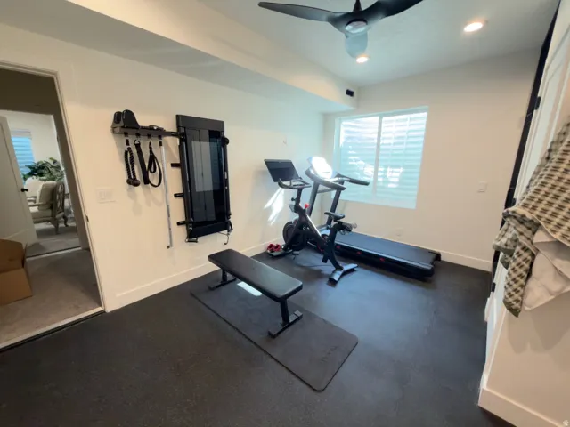 Dedicated exercise room featuring a rubberized floor, recessed lighting, and a ceiling fan