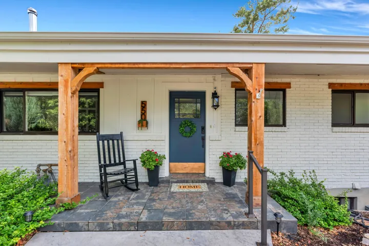 Covered entry with natural wood posts and exposed wood beams