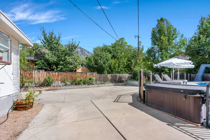 Concrete patio featuring a hot tub and mountain scenery