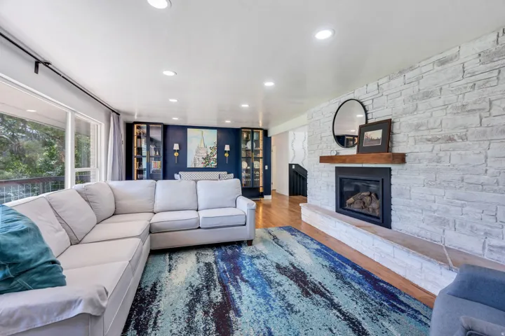 Stone-clad fireplace with wood mantle
