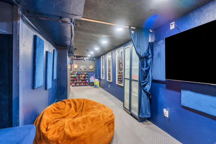 Recessed lighting illuminates the textured ceiling and walls