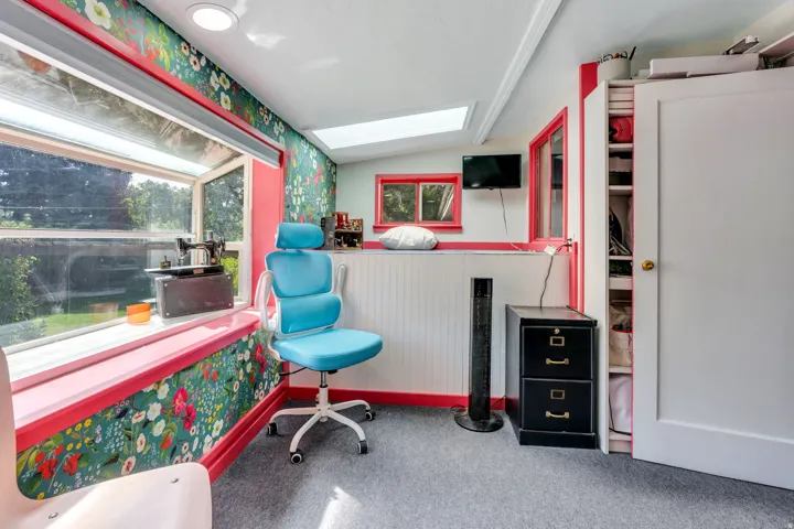 Expansive window with a wide sill, recessed lighting, skylight, and built-in shelving storage