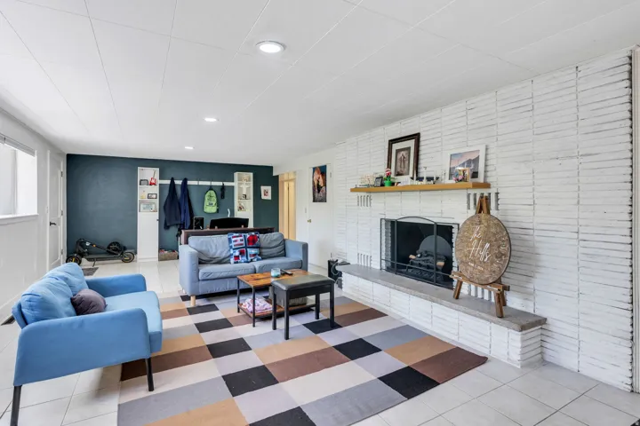 White painted brick fireplace with a wood mantel