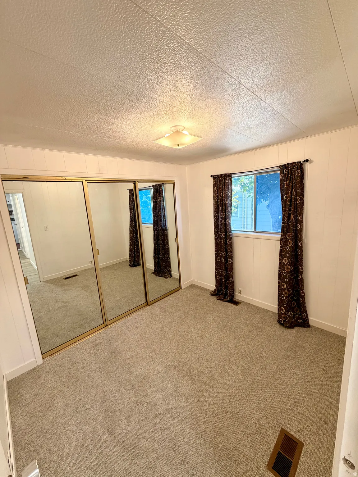 Wall-to-wall carpeting, dual windows, and mirrored closet doors