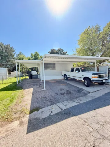 Paved driveway with an attached carport structure