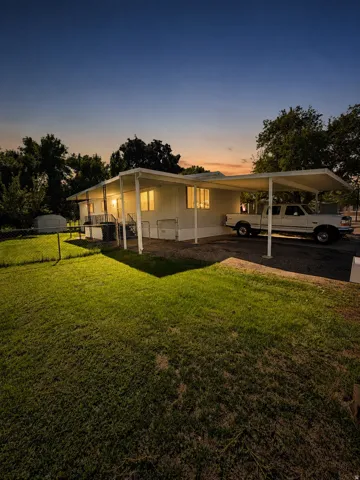 White single-story dwelling with a covered patio and an extended carport