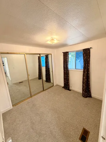 Wall-to-wall carpeting, dual windows, and mirrored closet doors