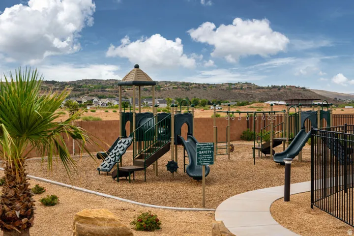 Playground area featuring multiple slides, monkey bars, and swings