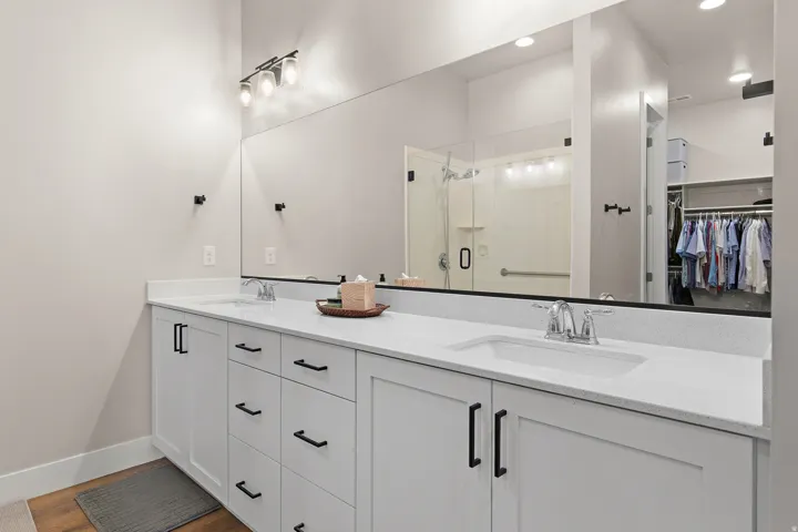 Dual vanity with white cabinetry and black hardware