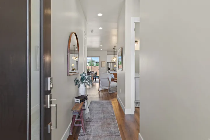 Dark wood-finish entry door with modern silver-tone hardware