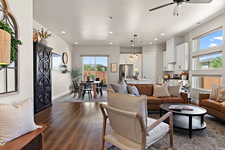 Recessed lighting, wood-finish flooring, ceiling fan, white cabinetry, and pendant lighting fixtures