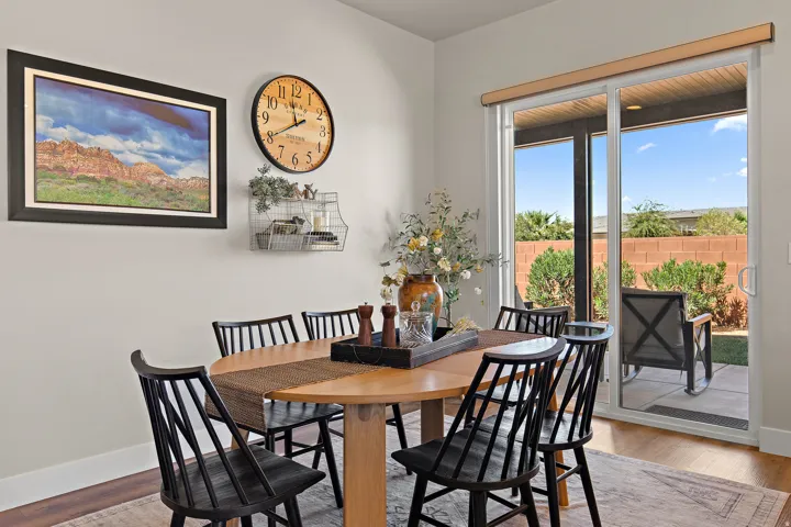 Recessed lighting, wood-finish flooring, and a sliding glass door providing access to an outdoor patio
