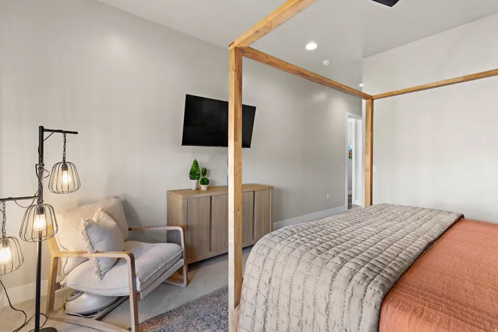 Recessed ceiling lighting, light-toned wall finishes, and wood-finish flooring