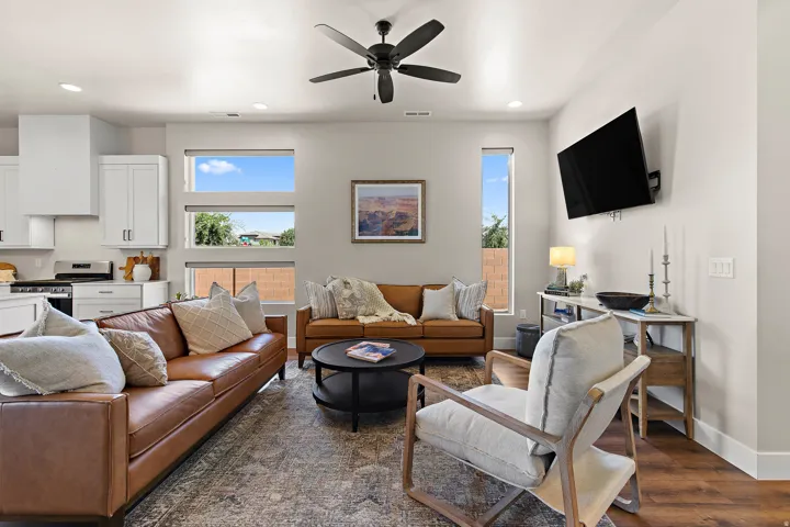 Recessed lighting, wood-finish flooring, and a ceiling fan with light fixture