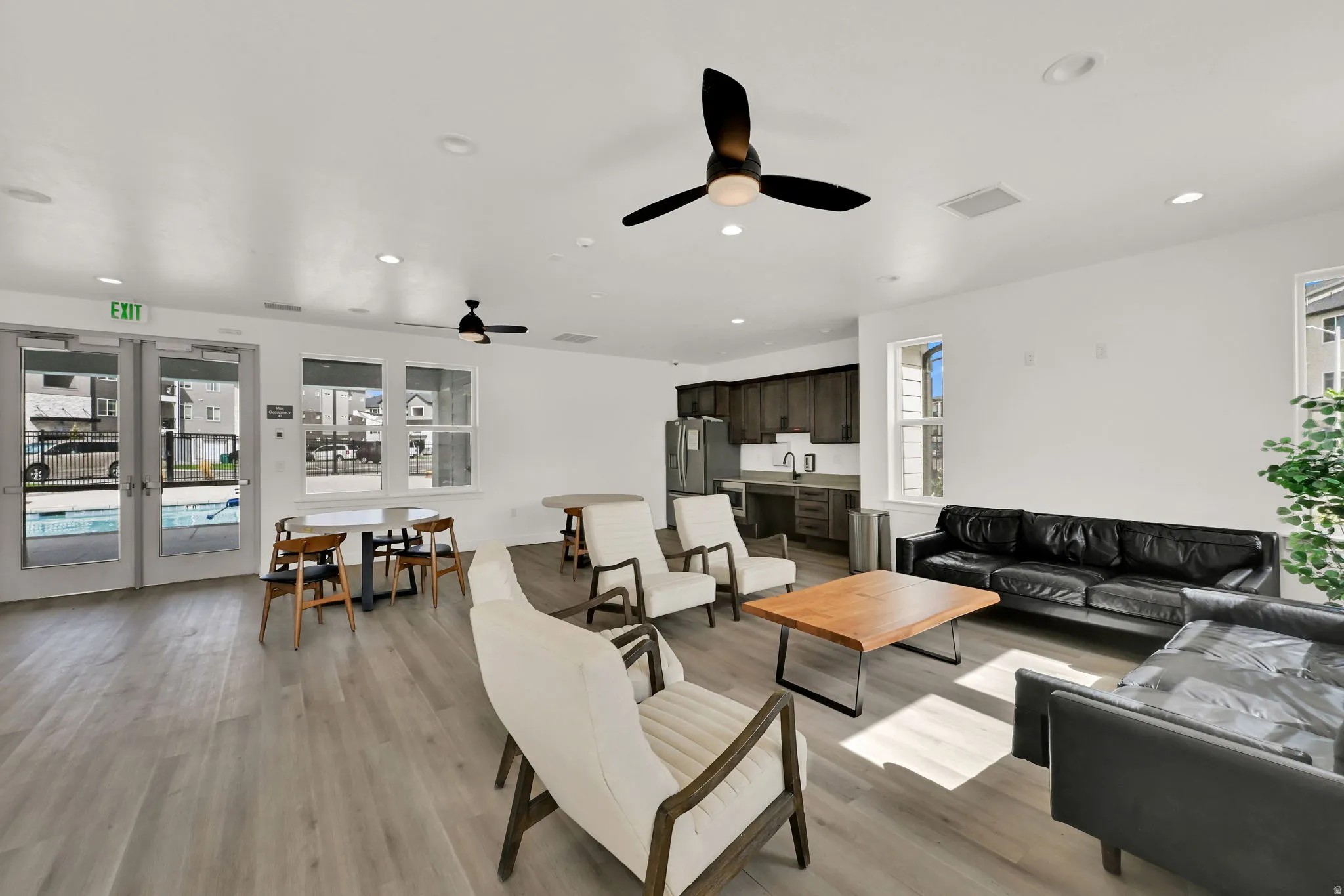 Open-concept common area featuring wood-finish flooring, recessed lighting, and ceiling fans