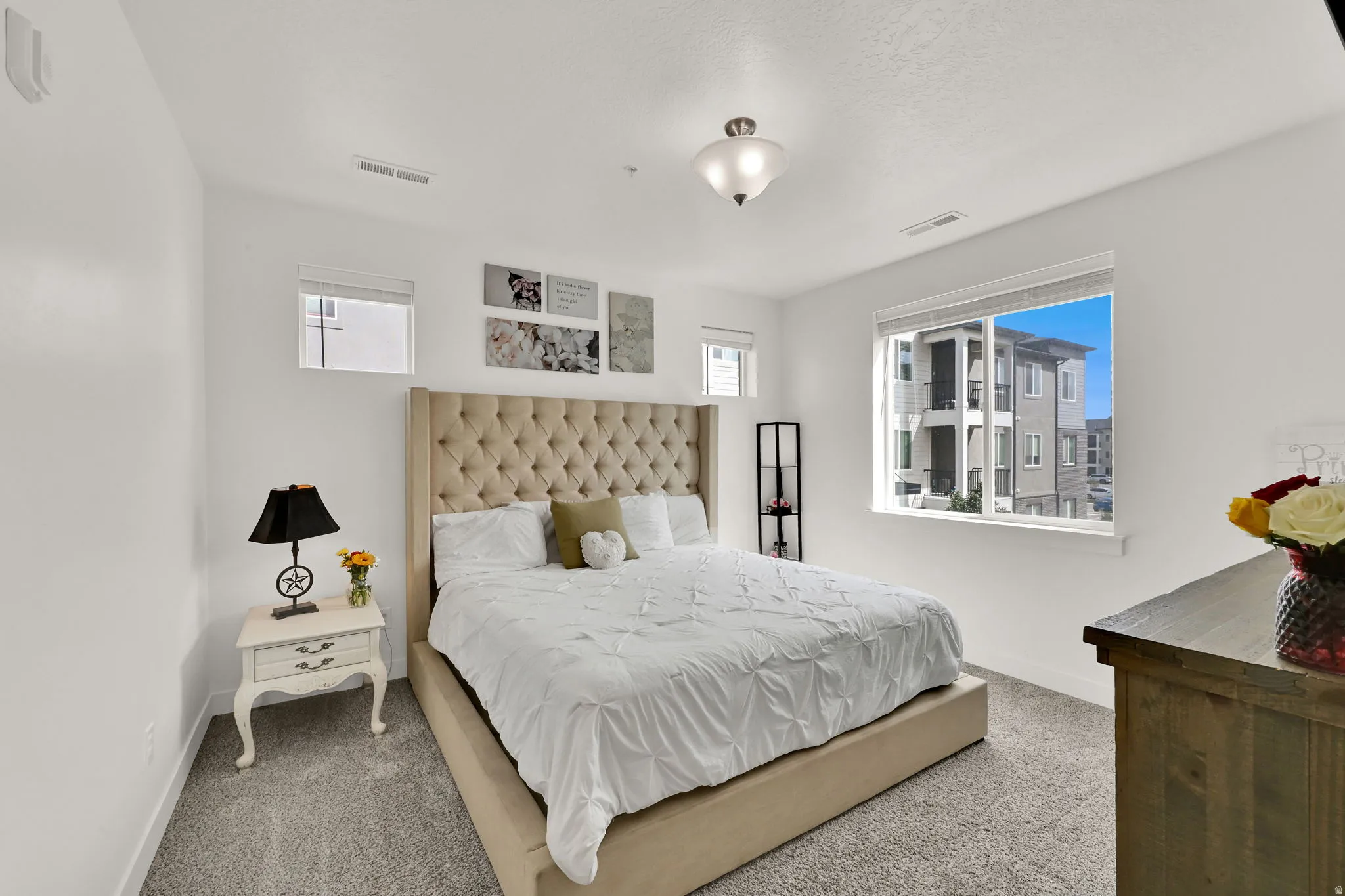 Neutral paint palette, recessed window, carpeted flooring, flush mount ceiling light, and additional window