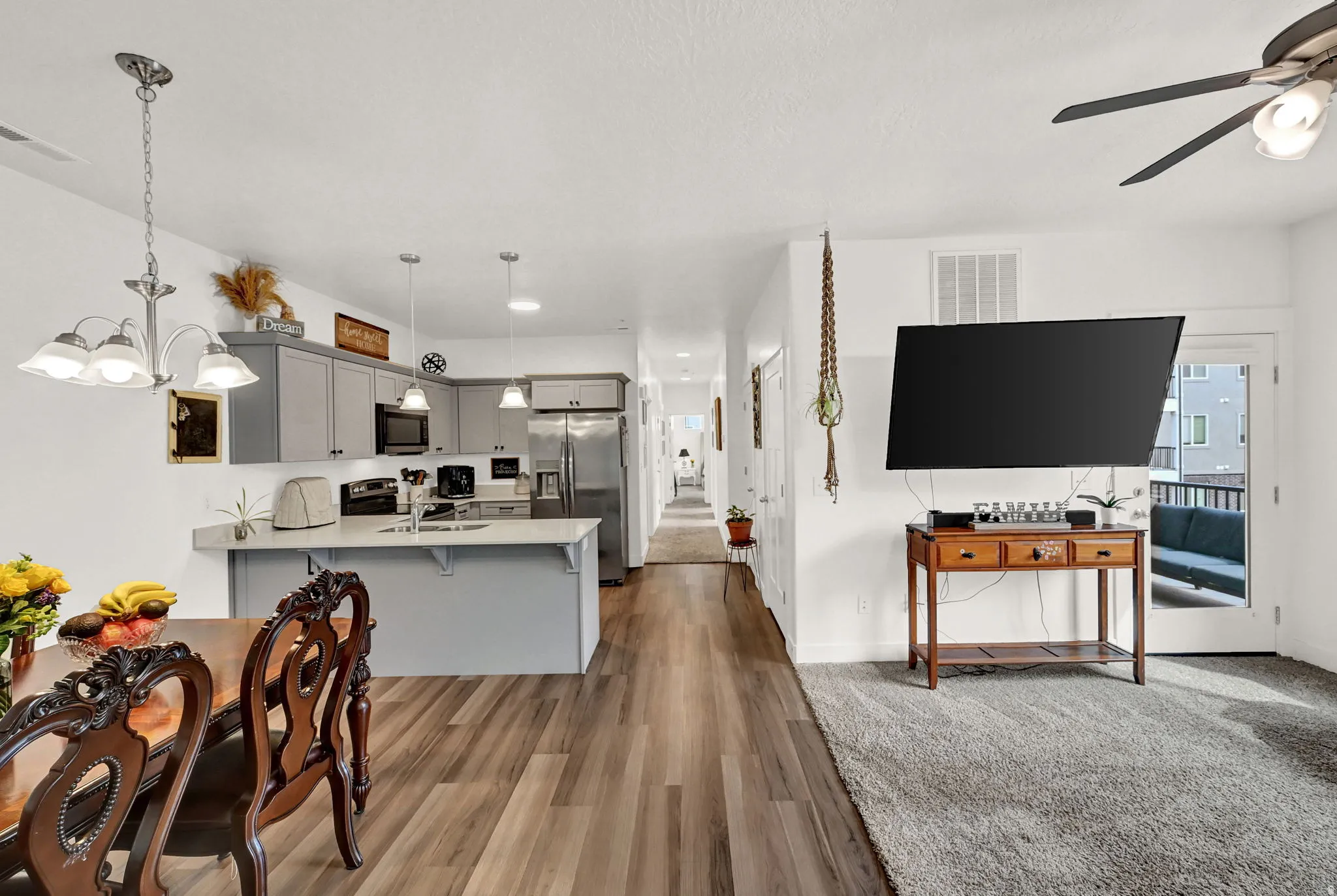 Open concept living area with LVP flooring and recessed lighting