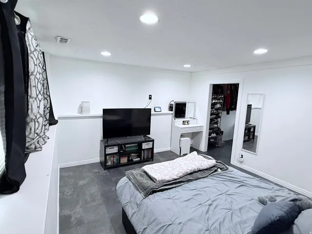 Recessed lighting, white walls, and gray flooring