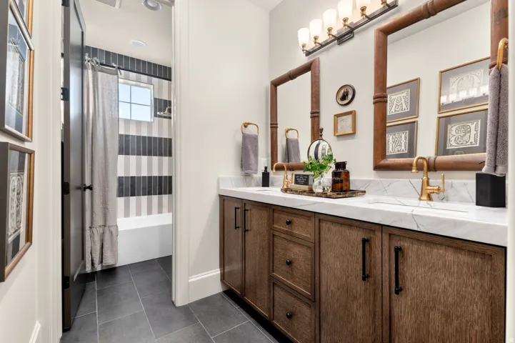 Dual vanity with a white countertop and gold-toned faucets