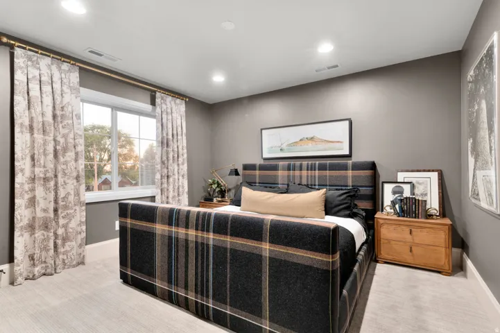 Recessed ceiling lighting, light gray wall paint, window with white trim, wood-finish flooring, and white baseboards