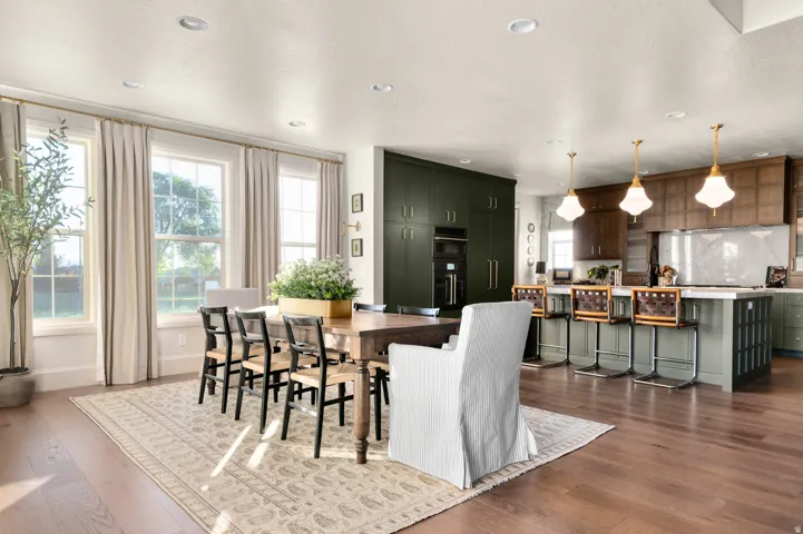 Open-concept living space featuring wood-finish flooring, recessed lighting, and a kitchen island with pendant lighting