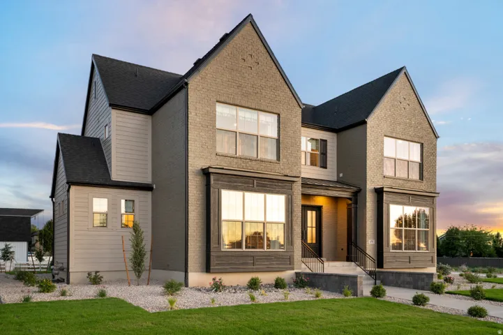 Exterior featuring brick and siding finishes, black shingle roofing, multiple gables, and prominent bay windows