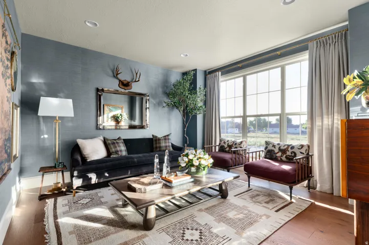 Hardwood flooring, recessed lighting, large pane windows, textured wallcovering, and a prominent wall mirror