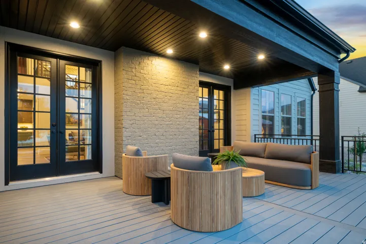 Covered outdoor patio featuring a slatted ceiling, recessed lighting, brick-clad exterior wall, and French patio doors