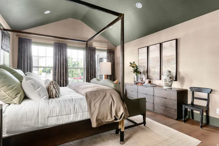Vaulted ceiling with accent paint, recessed lighting, and multiple windows with transoms
