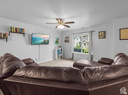 Recessed window with exterior views, ceiling fan, wall-mounted shelving, and neutral wall tones