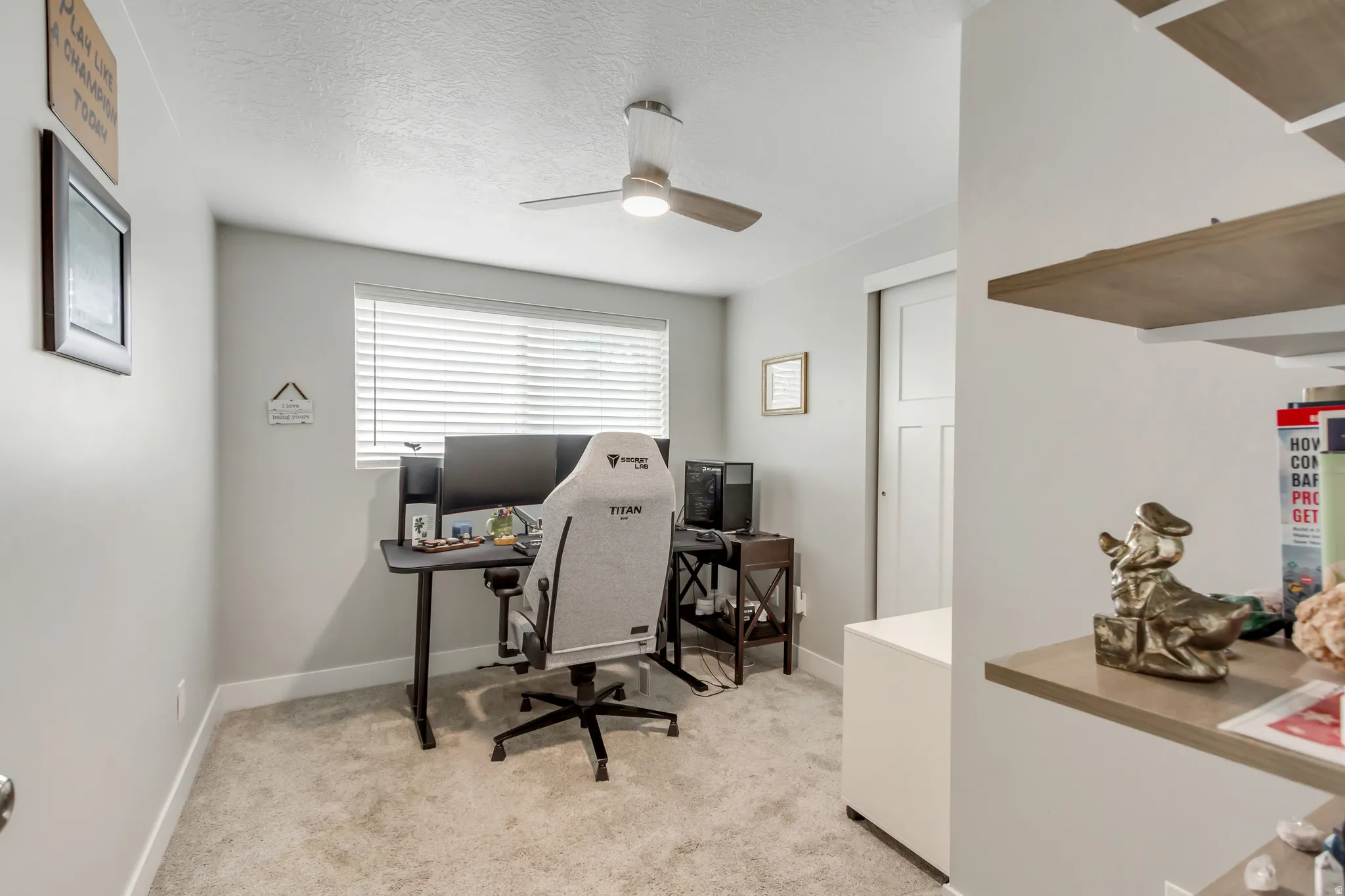 Neutral wall paint with carpet flooring, a ceiling fan with integrated lighting, and a window with horizontal blinds