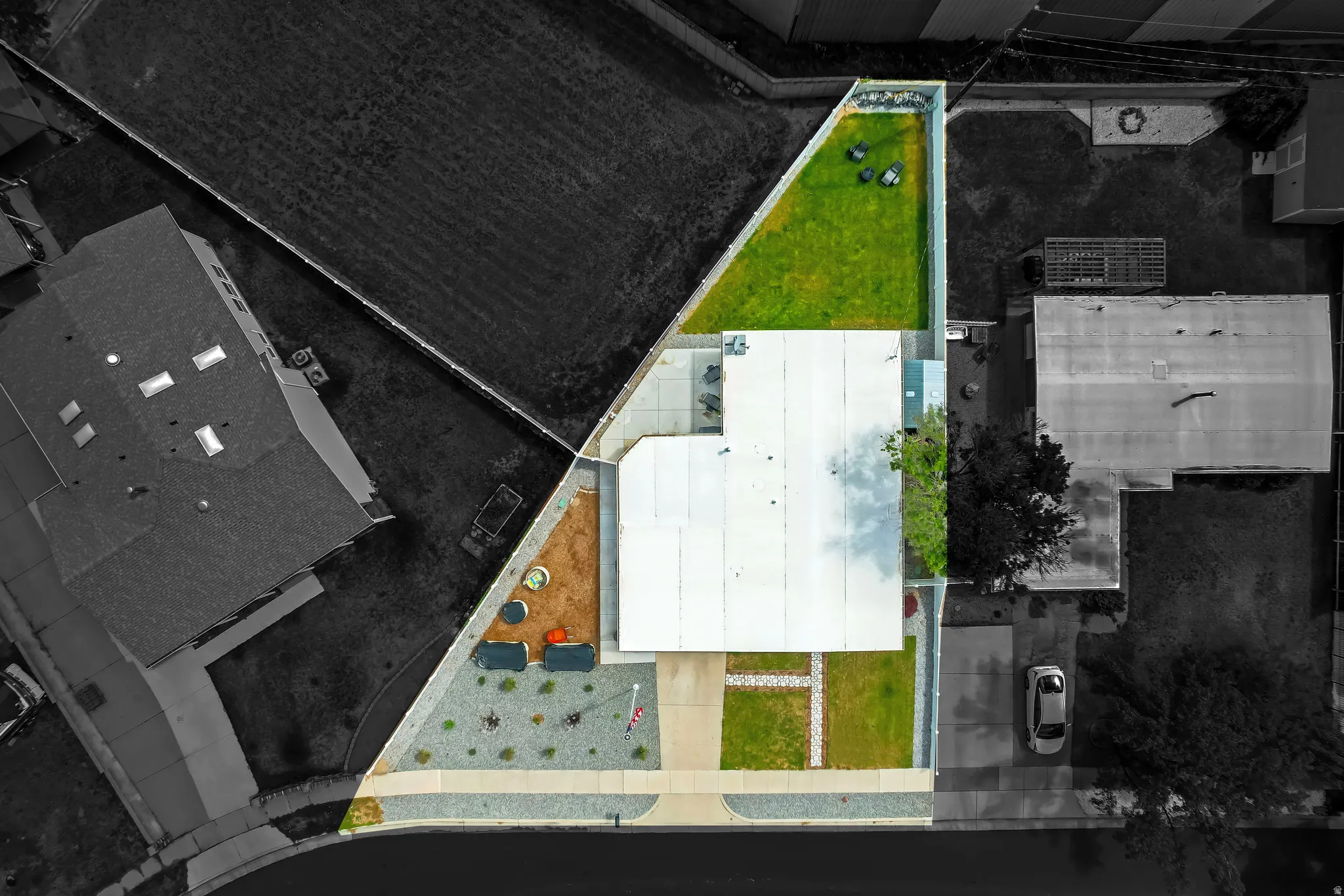 Modern flat-roof architecture with green lawn, gravel landscaping, and concrete pathways