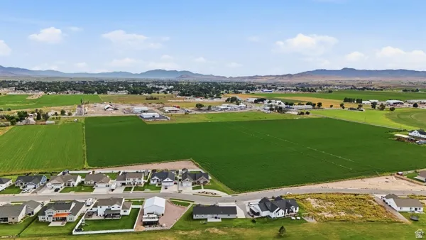 Community setting with residential properties, undeveloped land, and distant mountain ranges