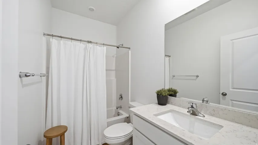 Integrated tub and shower with a shower curtain rod