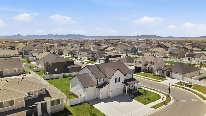 Aerial perspective of a residential neighborhood with distant mountains